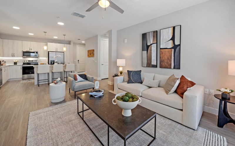 Wide open living areas perfect for entertaining a living room with a large ceiling fan a couch