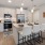 a kitchen and island with chairs
