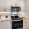 a kitchen with white cabinets a stovetop and a fridge