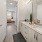 a bathroom with a large mirror and a tub