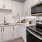a kitchen with white cabinets a stovetop and a sink