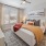 a bedroom with a bed and a fan and a window